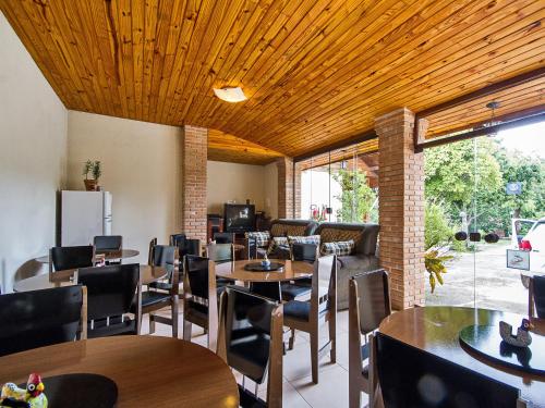 坎波斯杜若尔当圣本笃角落旅馆的餐厅设有木制天花板和桌椅