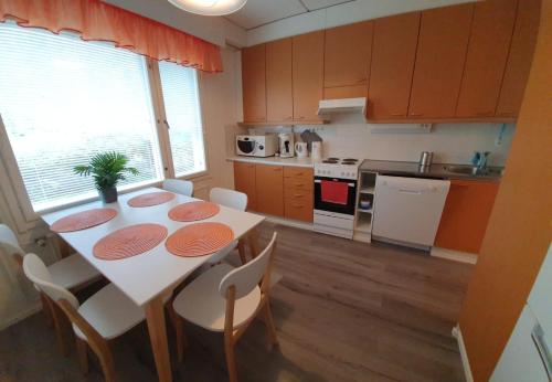 哈米纳Hamina Orange Apartments Ilves的带桌椅的厨房以及带桌椅的厨房。