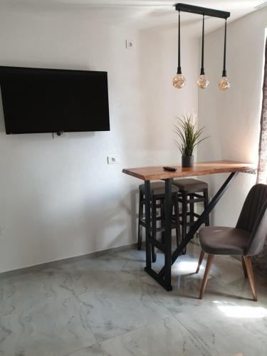 奥赫里德Apartments Lapidarium的用餐室配有桌椅和平面电视。