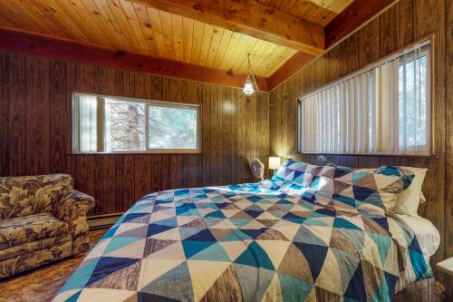 谢弗湖Pond View Lodge的卧室配有一张床铺,位于带木墙的房间内