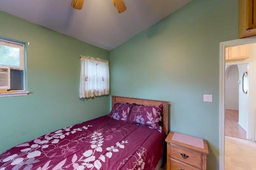 伊莎贝尔港Long Island Village Unit 081的一间卧室设有紫色的床和窗户