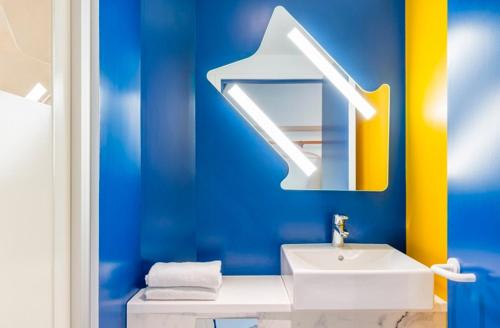 蒙彼利埃Ibis Budget Montpellier Nord Euromédecine的蓝色的浴室设有水槽和镜子