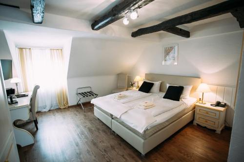 卡塞尔嘎斯霍夫帕彭安妮酒店的卧室配有一张白色大床和一张书桌