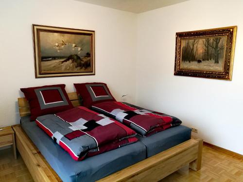 科布伦茨LUXURIÖSE FERIENWOHNUNG CONFLUENTIA IN DER KOBLENZER ALTSTADT的一间卧室配有一张红色和蓝色的棉被床