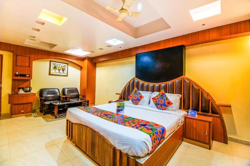 兰奇FabHotel Palash Residency Ranchi Railway Station的一间卧室配有一张床、一张桌子和一把椅子