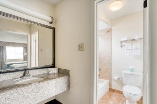 亚历山德里亚OYO Hotel Alexandria LA- Hwy 165的一间带水槽、卫生间和镜子的浴室