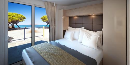 冯塔纳Victoria Mobilehome in Istra Premium Camping Resort的一间卧室设有一张床,享有海景