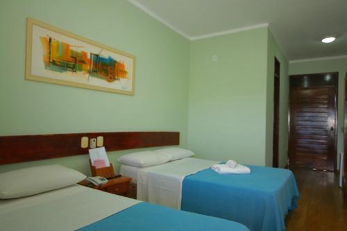 Hotel Pousada Dos Ventos客房内的一张或多张床位