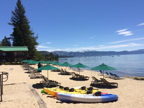 塔霍维斯塔奠雷拉托斯湖滨度假酒店的海滩上摆放着椅子和遮阳伞,还有船只