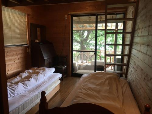 由布市似家心怡酒店的客房设有两张床和大窗户。