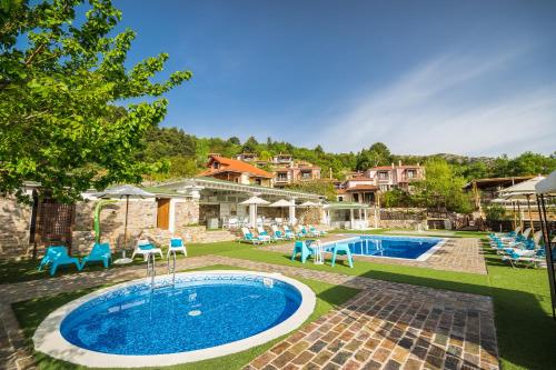 Tóriza伊拉艾拉避暑山庄酒店的一个带椅子的庭院和房子的游泳池
