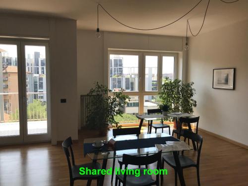 米兰Feel@Home Apartment+Rooms的用餐室设有桌椅和窗户。
