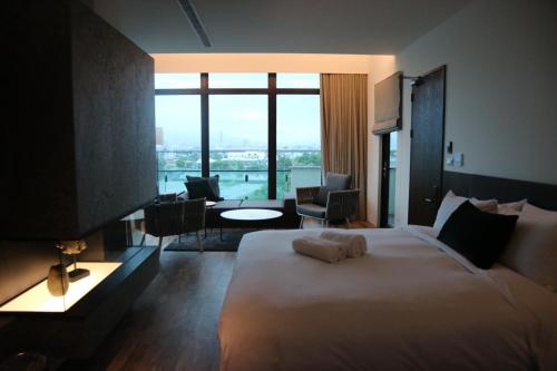 五结藏阔渡假会馆的酒店客房设有一张大床和大窗户