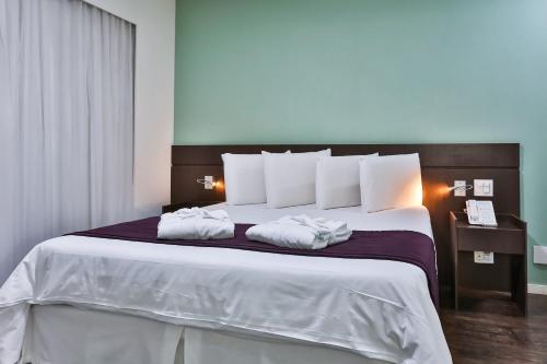 San Diego Suites Pampulha Hotel - Oficial客房内的一张或多张床位