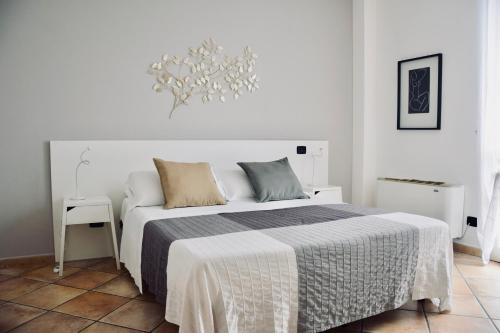 卡萨莱蒙费拉托珀逖克住宅酒店的白色卧室配有一张床和一个吊灯