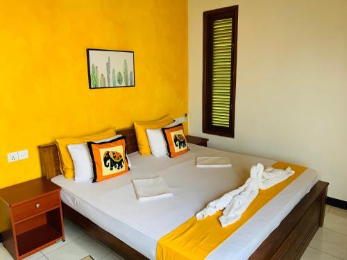 乌纳瓦图纳山姆住宿加早餐旅馆的黄色墙的房间里一张床位