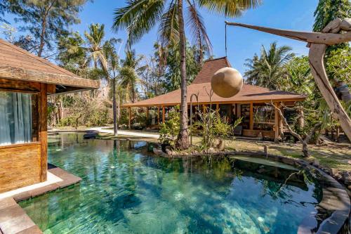 吉利特拉旺安昆诺别墅 的棕榈树屋前的游泳池