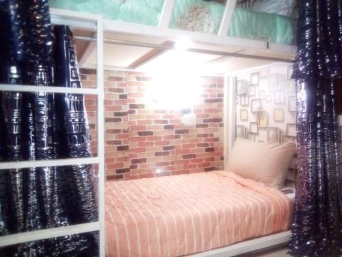 班敦孟Ban Kru Ae mixed dorm的砖墙客房内的双层床