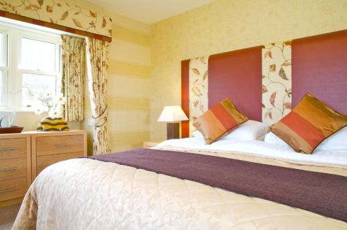 TomichThe Tomich Hotel的一间卧室设有一张大床和一个窗户。