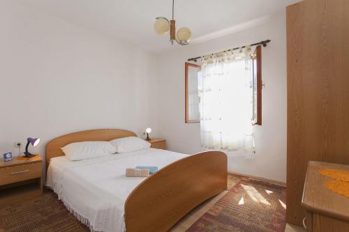 尼亚卢卡Villa Bistrana - 15m from sea的卧室配有白色的床和窗户。