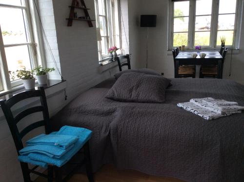 LangøLangø Overnatning的卧室配有床、桌子和窗户。