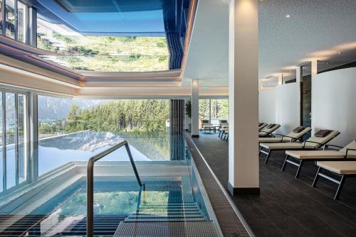 毛拉赫Naturhotel Alpenblick的酒店大堂设有游泳池和自动扶梯