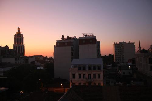 巴统MELINI Boutique Hotel的日落时分享有城市天际线的景致