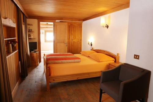 利维尼奥白塔卢勒塔住宿加早餐旅馆的一间卧室配有一张床和一把椅子
