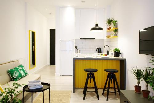 巴统Banana Apartments的一间厨房,内设一个柜台和凳子