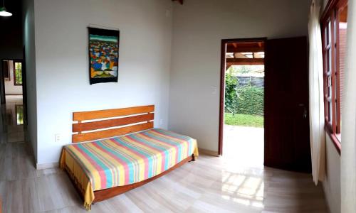 弗洛里亚诺波利斯Monsal Casa para Temporada的一间卧室配有一张带木制床头板的床
