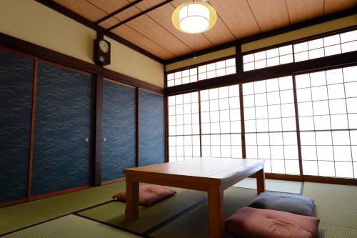 富山Guesthouse Iwase的客房设有桌子和窗户。