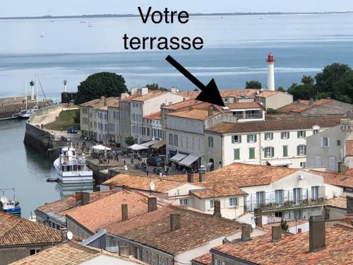 圣马丹德雷La terrasse sur les toits的享有小镇美景,设有白色灯塔