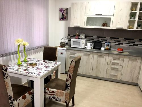 克拉多沃Apartman Bondi的厨房配有桌椅和微波炉。