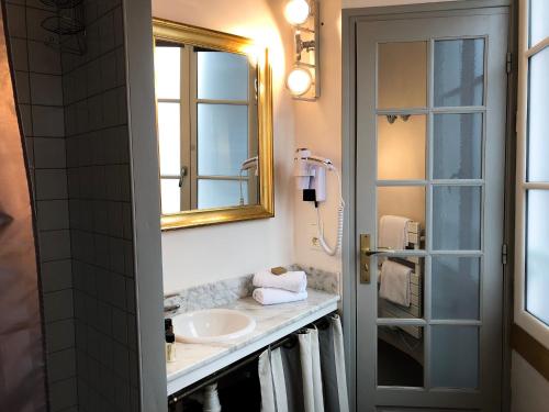 翁弗勒尔和地球之间的海酒店的一间带水槽和镜子的浴室