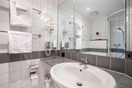 哈尔慕尼黑展览品质酒店及套房的白色的浴室设有水槽和镜子