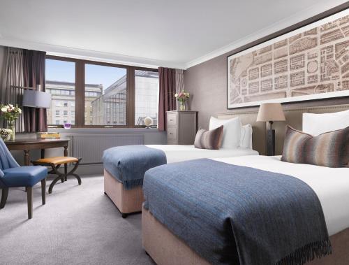 爱丁堡InterContinental Edinburgh The George, an IHG Hotel的酒店客房配有两张床和一张书桌