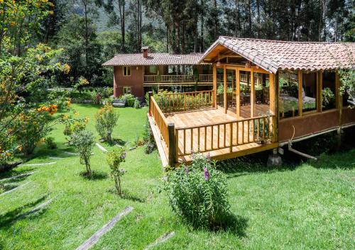 乌鲁班巴神圣梦想小屋酒店的庭院中带甲板的小房子