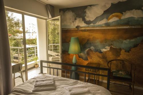地拉那Vanilla Sky Boutique Hostel的卧室墙上有绘画作品
