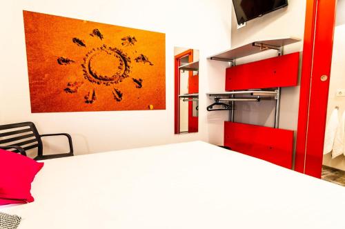 帕洛斯德拉夫龙特拉ALIOCIO的卧室配有一张床,墙上挂有绘画作品