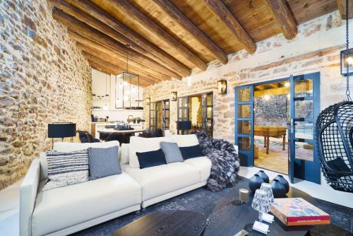 摩拉鲁比罗Valencia Luxury - Mora de Rubielos con Piscina的客厅配有白色沙发和砖墙