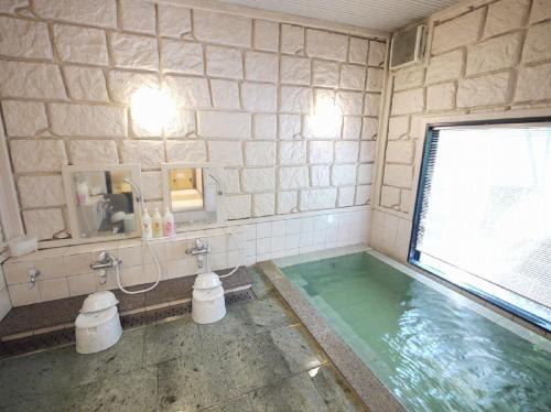 多治见市多治见路线酒店的一间带大窗户的游泳池的浴室