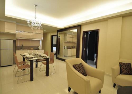 吉隆坡吉隆坡达马斯套房及公寓式酒店的用餐室以及带桌椅的起居室。