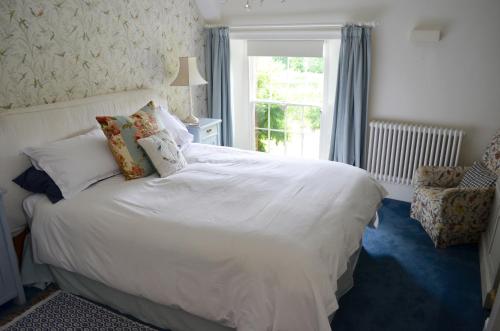 淡水Stroud House的卧室配有白色的床和窗户。