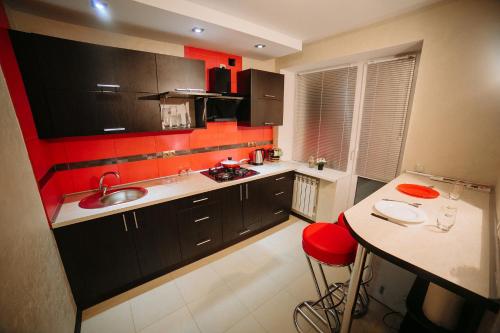 戈梅利Apartment on Lenin Avenue的一个带水槽和红色墙壁的厨房