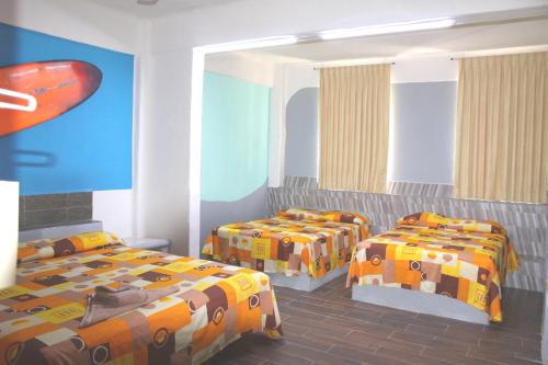 Hotel Arrecife Huatulco Plus客房内的一张或多张床位