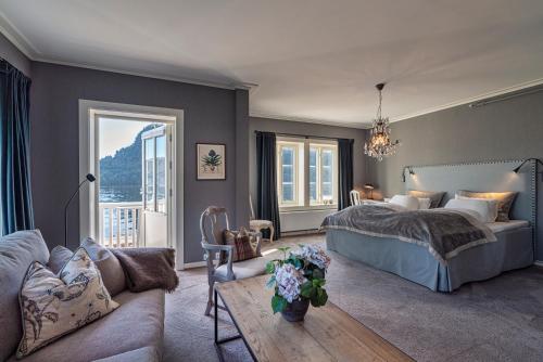 AngvikAngvik Gamle Handelssted - by Classic Norway Hotels的一间卧室配有一张床和一张沙发