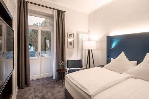 巴特莱辛哈尔Villa Rein Boutiquehotel的酒店客房设有床和窗户。