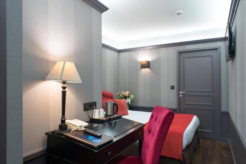 里昂亚历山德拉酒店的酒店客房配有书桌、床和床,