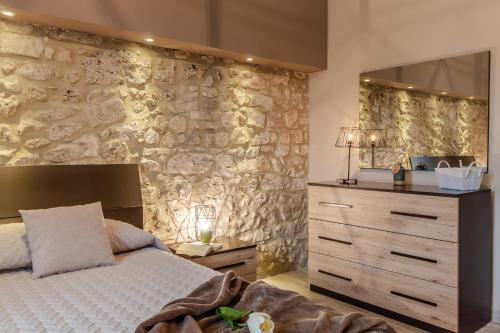 特尔尼La Casa Rosa的一间卧室设有一张床和石墙