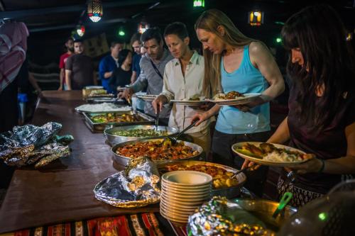 瓦迪穆萨Ammarin Bedouin Camp的一群人,在自助餐中拿着食物盘